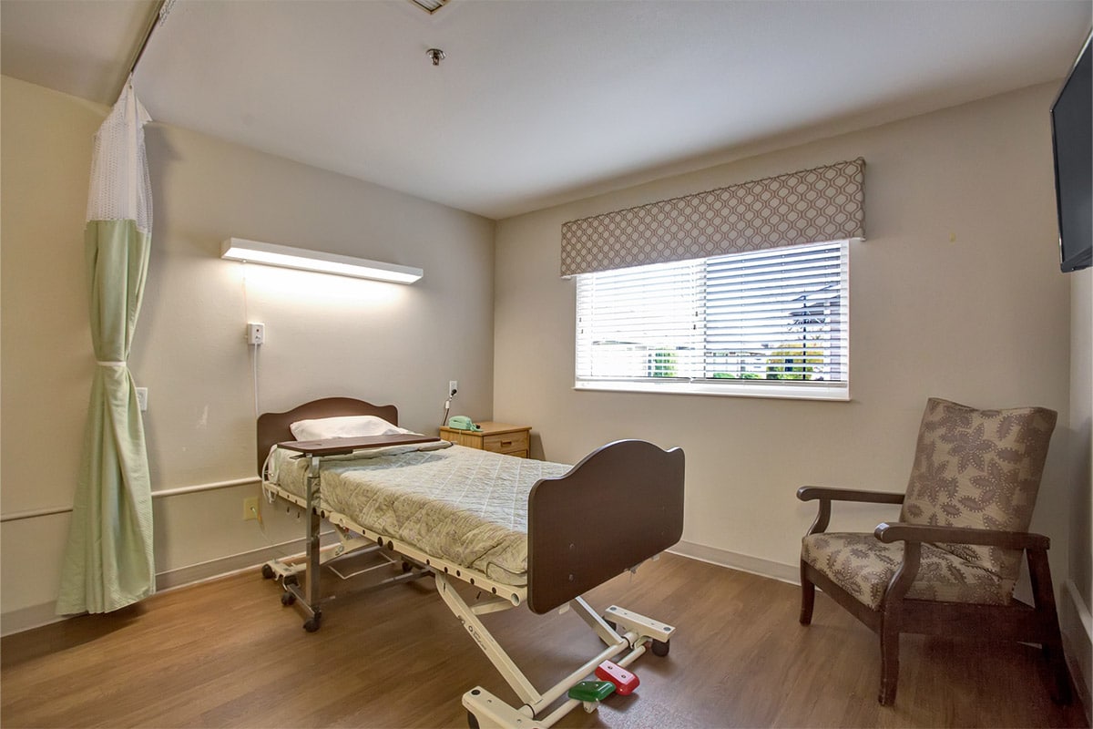 Private room with chair at South Creek Post Acute
